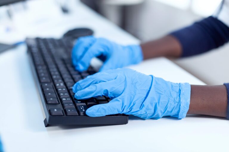 Close up of african researcher holding hands on computer keyboard